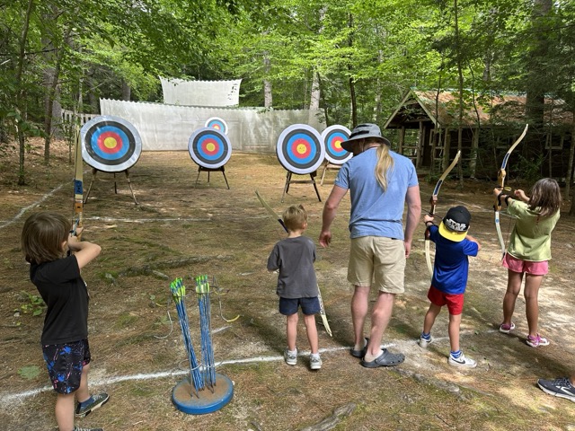 Little Loons learning archery with an instructor at the camp range