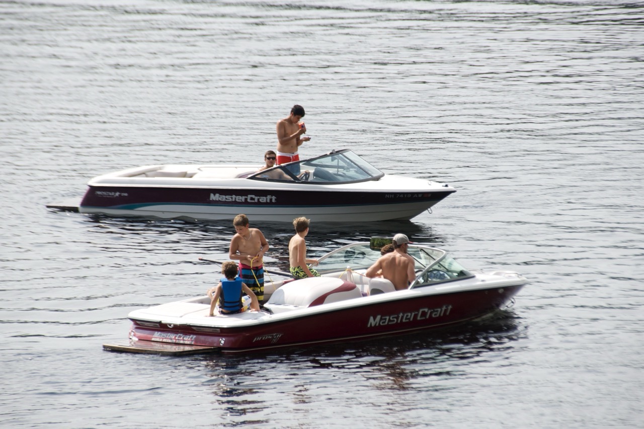Two MasterCraft ski boats idling on Bear Lake as campers prep ropes for the next waterski set