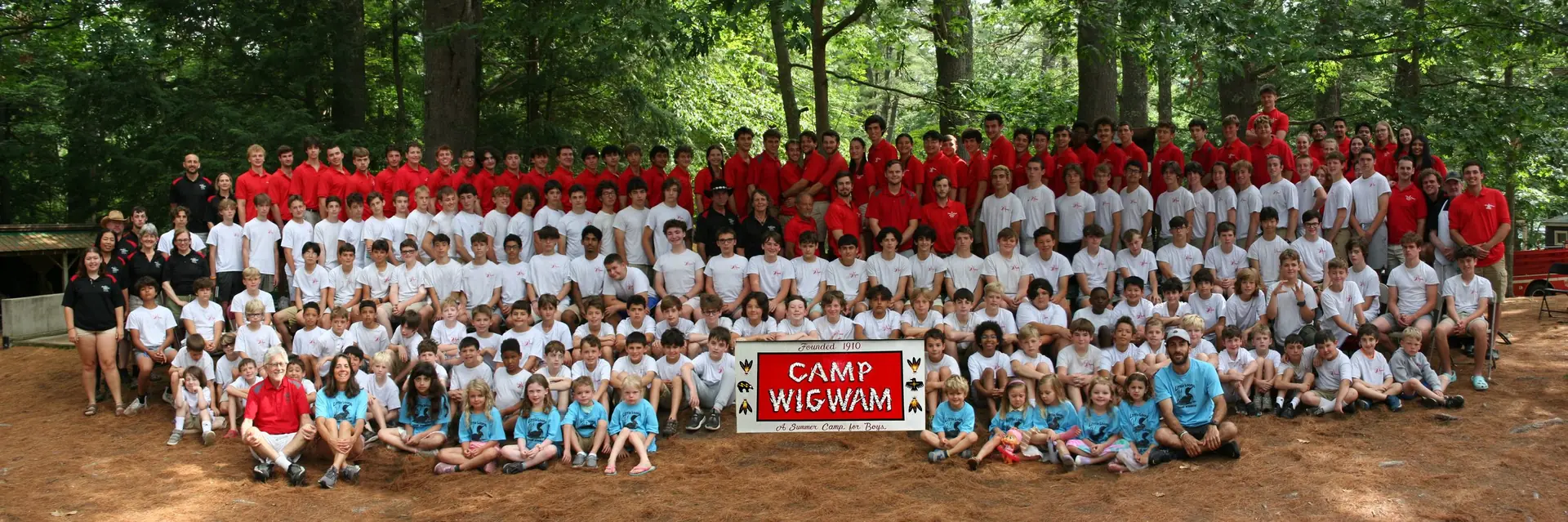 Camp Wigwam counselors and leadership team posing together at the lodge